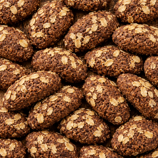 Biscottini al cioccolato e avena sparsi sul tavolo, quadrato pieno